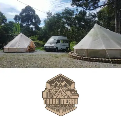 a tent and a van parked in a field at Tanah Merah Glamping Village (TMGV) in Kuala Kangsar