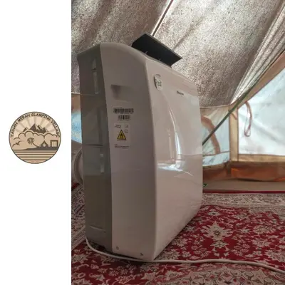 a washing machine sitting on a rug in a tent at Tanah Merah Glamping Village (TMGV) in Kuala Kangsar