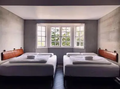 two beds in a room with two windows at 80 Colonie Fraser's Hill 4pax in Bukit Fraser