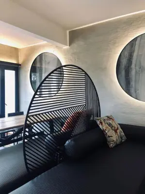 a black couch in a living room with two windows at 80 Colonie Fraser's Hill 4pax in Bukit Fraser