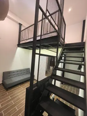 a spiral staircase with a bench in a room at The Magazine Boutique Hotel in George Town