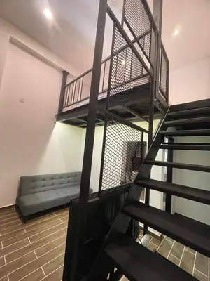 a staircase in a room with a bench and a stair case at The Magazine Boutique Hotel in George Town