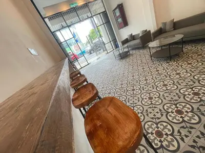a lobby with a table and chairs in a building at The Magazine Boutique Hotel in George Town