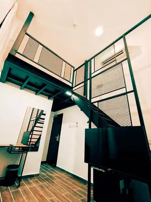 a room with a staircase and a stair case at The Magazine Boutique Hotel in George Town