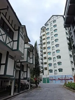 an empty street in front of two tall buildings at Awesome Homestay Apartment @ Equatorial Hill Resort in Brinchang
