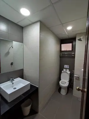 a bathroom with a sink and a toilet at Awesome Homestay Apartment @ Equatorial Hill Resort in Brinchang