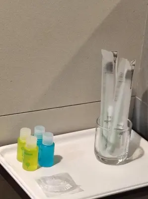 a glass vase and some bottles on a tray at Awesome Homestay Apartment @ Equatorial Hill Resort in Brinchang