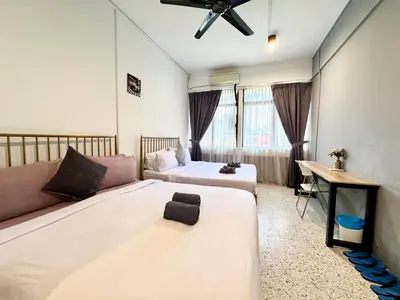 a hotel room with two beds and a couch at Mac Inn 94 in George Town
