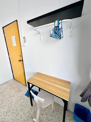 a desk and a chair in a room at Mac Inn 94 in George Town