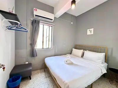 a small bedroom with a bed and a window at Mac Inn 94 in George Town