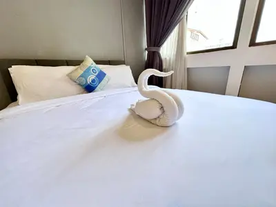 a white snake sitting on top of a bed at Mac Inn 94 in George Town