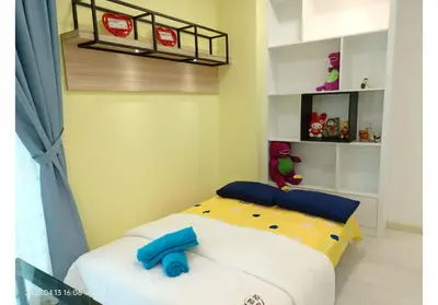 a bedroom with a bed with a yellow and blue comforter at City Town 2-6 Pax Beautiful View Cozy Condo, Jelutong, Georgetown, Centre Heart Of Penang Island, near Highway Komtar Gurney in George Town