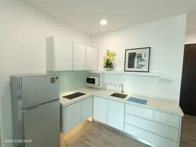 a kitchen with white cabinets and a stainless steel refrigerator at City Town 2-6 Pax Beautiful View Cozy Condo, Jelutong, Georgetown, Centre Heart Of Penang Island, near Highway Komtar Gurney in George Town