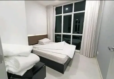a room with two beds in front of a window at City Town 2-6 Pax Beautiful View Cozy Condo, Jelutong, Georgetown, Centre Heart Of Penang Island, near Highway Komtar Gurney in George Town