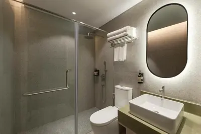 a bathroom with a toilet and a sink and a mirror at Citadines Connect Georgetown Penang in George Town
