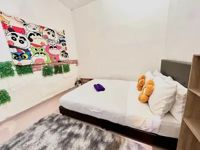 a bedroom with a bed with a teddy bear on it at Cozy 255 Entire 3 Bedroom House At Alma Bukit Mertajam in Bukit Mertajam