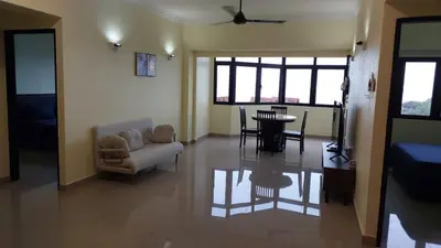 a living room with a couch and a table at Batu Ferringhi Luxury Seaview Suite - 3Br in Batu Ferringhi