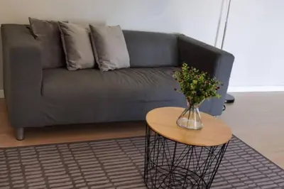 a living room with a couch and a table with a vase of flowers at Lovers under Cupid's Arrow 丘比特之箭下の恋人 in Butterworth