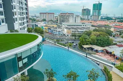 a building with a swimming pool in a city at Blue Aesthetic Luxury Seaview 3 min Drive Sunway in Butterworth