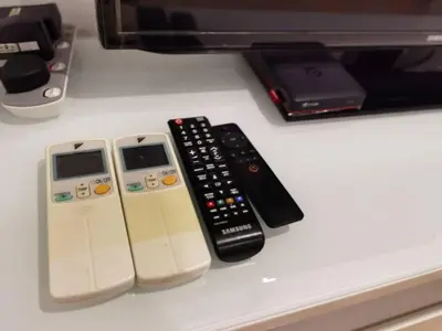 a group of remote controls sitting on top of a counter at YOU & ME 118 SWEET HOUSE in Tanjong Tokong