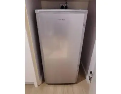 a white refrigerator in a corner of a room at YOU & ME 118 SWEET HOUSE in Tanjong Tokong