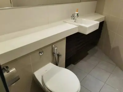 a bathroom with a white toilet and a sink at YOU & ME 118 SWEET HOUSE in Tanjong Tokong