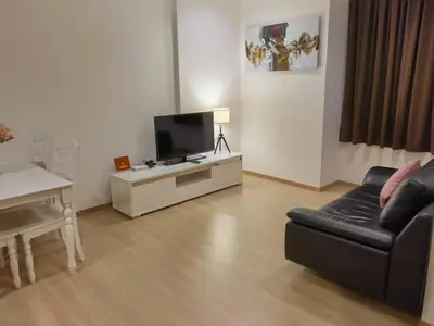 a living room with a couch and a television at YOU & ME 118 SWEET HOUSE in Tanjong Tokong