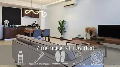 a living room with a couch and a table at Deluxe Seaview Suite Twin Bed by The Only Bnb in Tanjong Tokong