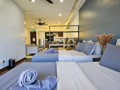 a hotel room with two beds and a kitchen at Deluxe Seaview Suite Twin Bed by The Only Bnb in Tanjong Tokong