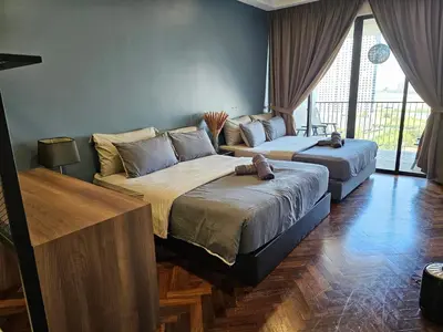 two beds sitting in a room with at Deluxe Seaview Suite Twin Bed by The Only Bnb in Tanjong Tokong