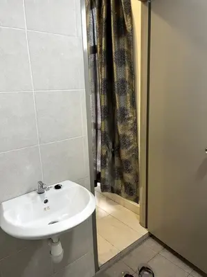 a bathroom with a white sink and a shower at Azzalea Homes 6 @ Taman Golden Hills Cameron Highlands in Tanah Rata