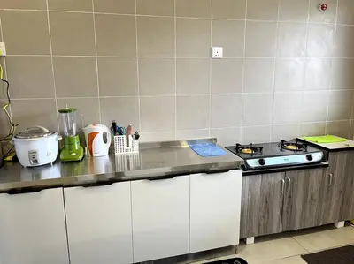 a kitchen with a stove and a counter top at Azzalea Homes 6 @ Taman Golden Hills Cameron Highlands in Tanah Rata