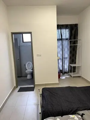 a bedroom with a bed and a bathroom with a toilet at Azzalea Homes 6 @ Taman Golden Hills Cameron Highlands in Tanah Rata