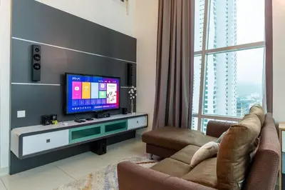a living room with a flat screen tv and a couch at 2Bedrooms Maritime Luxury Seaview Suite 2-10pax in Jelutong
