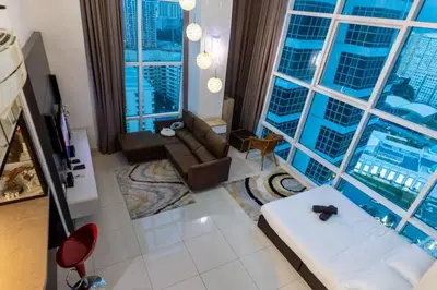 a living room with a view of a building at 2Bedrooms Maritime Luxury Seaview Suite 2-10pax in Jelutong