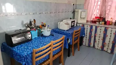 two tables in a kitchen with blue table cloth at LOST WORLD OF TAMBUN HOMESTAY in Kampong Batu Lapan