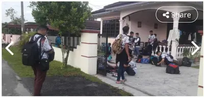 a group of people standing outside of a house at LOST WORLD OF TAMBUN HOMESTAY in Kampong Batu Lapan