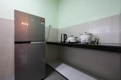 a kitchen with a stainless steel refrigerator and a counter at Moonight Luxe Suite, Cameron's Emerald Avenue in Brinchang