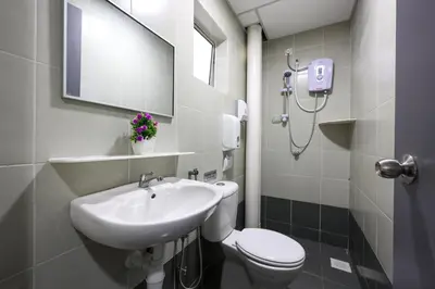 a bathroom with a sink and a toilet and a mirror at Moonight Luxe Suite, Cameron's Emerald Avenue in Brinchang