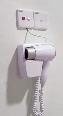 a white phone is hanging on a wall at Moonight Luxe Suite, Cameron's Emerald Avenue in Brinchang