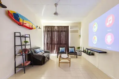 a living room with a couch and a chair at EE's Surfer's House - Seaview, 3 min walk to beach in Batu Ferringhi