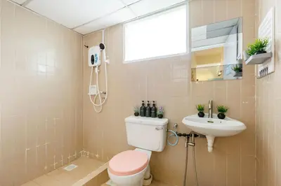 a bathroom with a toilet and a sink at EE's Surfer's House - Seaview, 3 min walk to beach in Batu Ferringhi