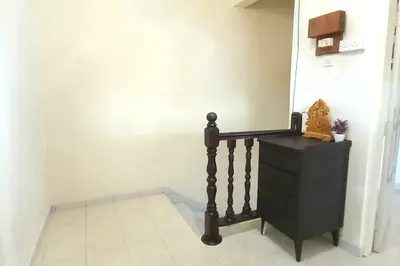 a hallway with a black dresser and a wall at 5 Bedroom 2 Bathrooms End-lot House, 3 parkings - Ipoh, Tambun in Ipoh