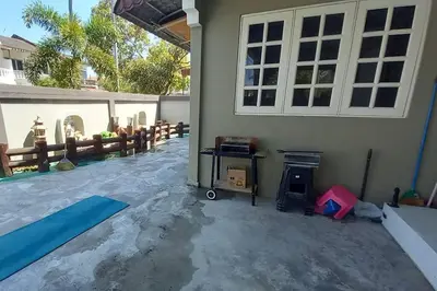 a backyard with a pool and a house at 5 Bedroom 2 Bathrooms End-lot House, 3 parkings - Ipoh, Tambun in Ipoh