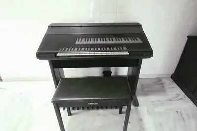 a black piano with a stool in a room at 5 Bedroom 2 Bathrooms End-lot House, 3 parkings - Ipoh, Tambun in Ipoh