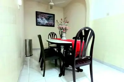 a dining room with a red table and chairs at 5 Bedroom 2 Bathrooms End-lot House, 3 parkings - Ipoh, Tambun in Ipoh