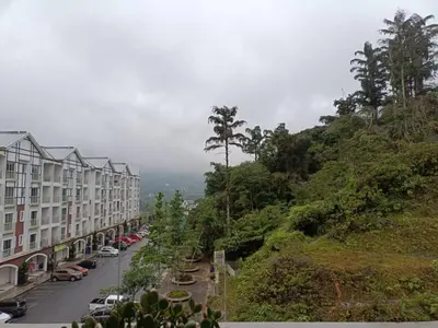 a city street with cars parked on a hill at Alyaleesya homestay muslim night market in Brinchang