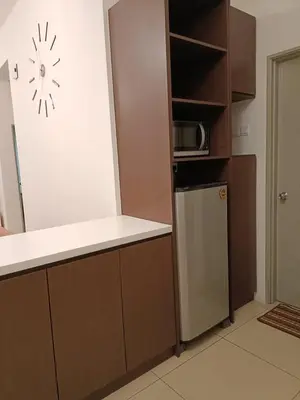 a kitchen with a refrigerator and a microwave at Alyaleesya homestay muslim night market in Brinchang