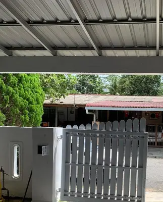 a white fence in front of a building at Jasmine Homestay Meru Ipoh in Ipoh
