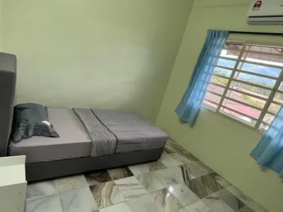 a small bedroom with a bed and a window at Homestay Malim Nawar in Malim Nawar